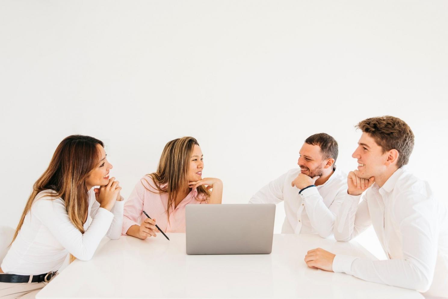 Financial analysis workspace with charts and documents spread across a desk